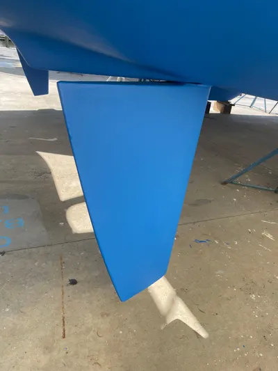 Wander Cat Yacht Photos Pics Blue rudder of a 2004 Lagoon 380 catamaran on dry dock.