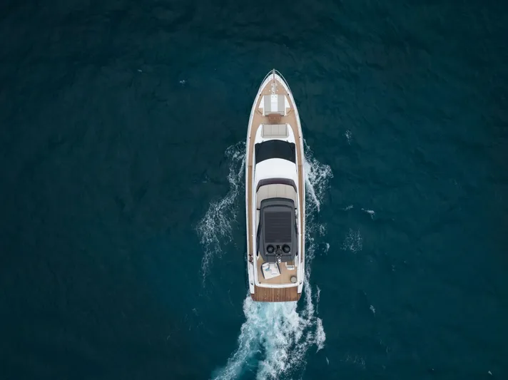Calma Yacht Photos Pics Aerial view of 2023 Ferretti Yachts 720 cruising on open water.