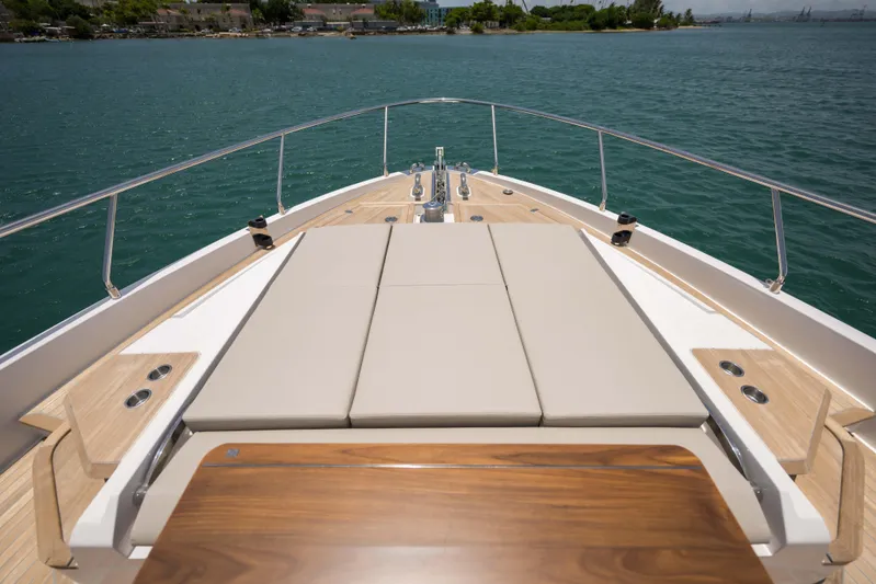 Calma Yacht Photos Pics Luxurious 2023 Ferretti Yachts 720 deck with sunbathing area and ocean view.