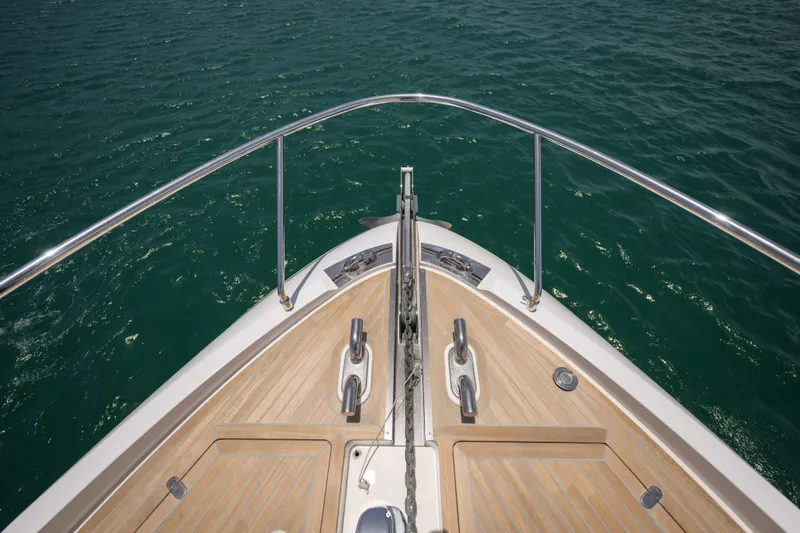 Calma Yacht Photos Pics Ferretti Yachts 720 bow, 2023 model, with teak deck and stainless steel railings.