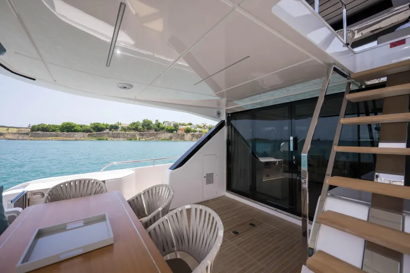 Calma Yacht Photos Pics Luxurious 2023 Ferretti Yachts 720 deck with seating and ocean view.
