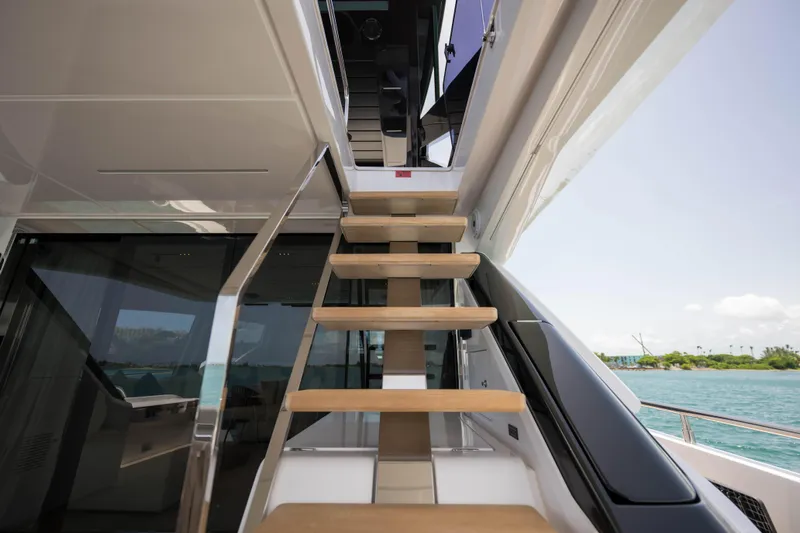 Calma Yacht Photos Pics Staircase on 2023 Ferretti Yachts 720, leading to upper deck with ocean view.