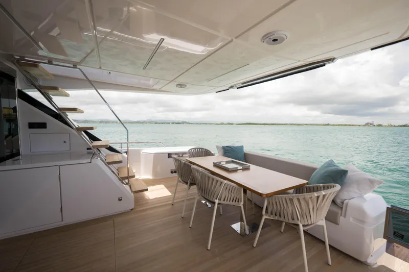 Calma Yacht Photos Pics Luxurious 2023 Ferretti Yachts 720 deck with elegant seating and ocean view.