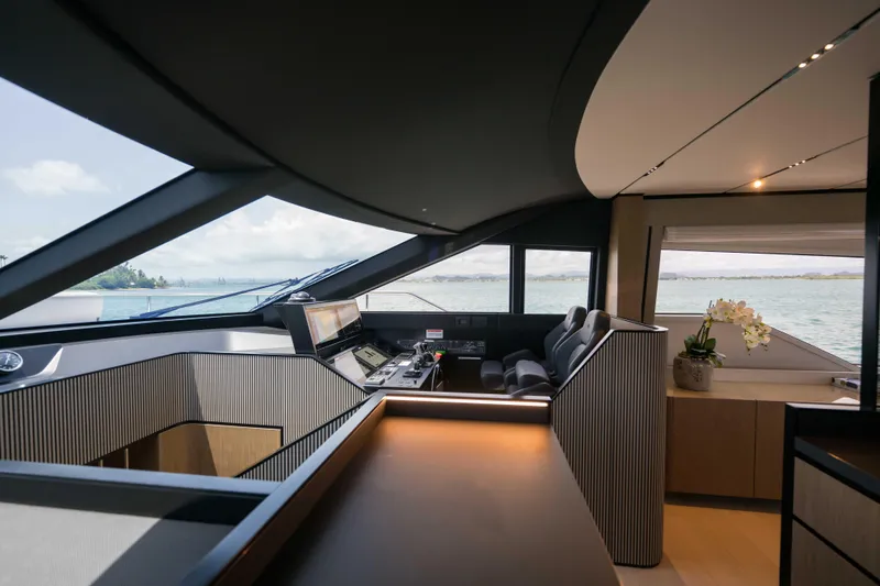 Calma Yacht Photos Pics Luxurious interior of 2023 Ferretti Yachts 720, featuring modern helm and panoramic windows.