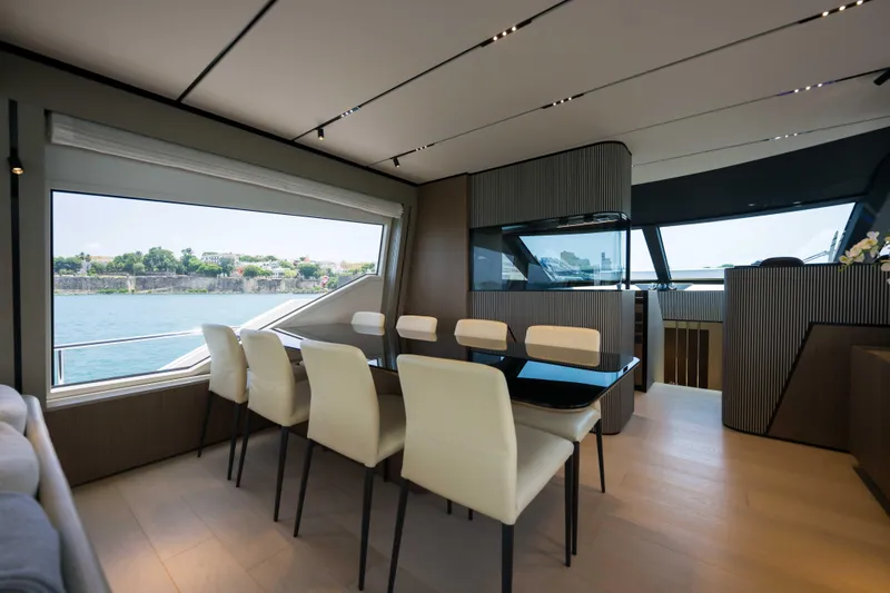Calma Yacht Photos Pics Luxurious interior of 2023 Ferretti Yachts 720 with elegant dining area and scenic views.