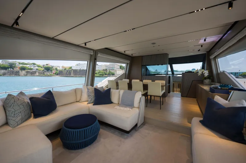 Calma Yacht Photos Pics Luxurious interior of 2023 Ferretti Yachts 720 with elegant seating and dining area.