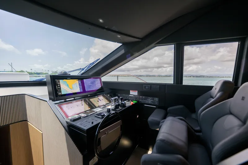 Calma Yacht Photos Pics Luxurious 2023 Ferretti Yachts 720 helm with advanced navigation systems and plush seating.