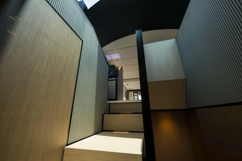 Calma Yacht Photos Pics Interior staircase of 2023 Ferretti Yachts 720, featuring modern design and wood accents.