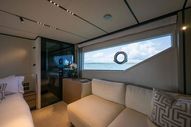 Calma Yacht Photos Pics Luxurious interior of 2023 Ferretti Yachts 720 with ocean view window.