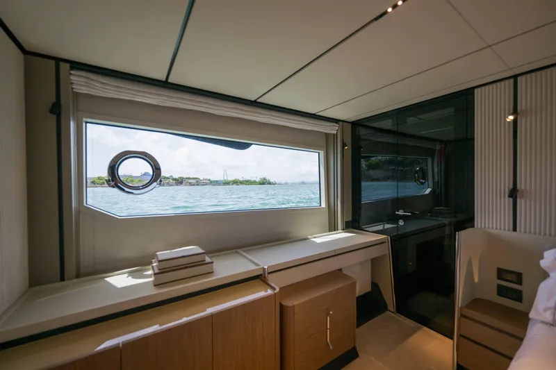 Calma Yacht Photos Pics Luxurious interior of 2023 Ferretti Yachts 720 with ocean view window.