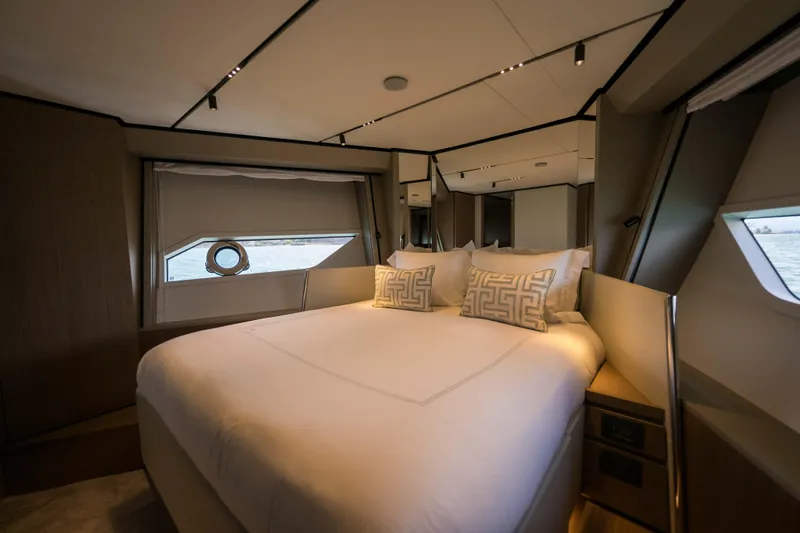Calma Yacht Photos Pics Luxurious bedroom interior of 2023 Ferretti Yachts 720 with elegant bedding and modern design.