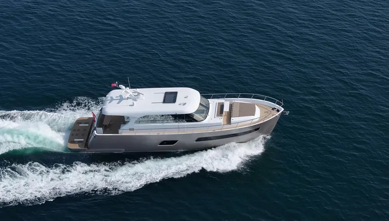  Yacht Photos Pics 2025 Altima Express Coupe 65 yacht cruising on open sea.