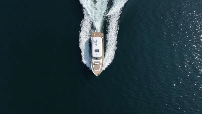  Yacht Photos Pics Aerial view of 2025 Altima Express Coupe 65 yacht cruising on open water.