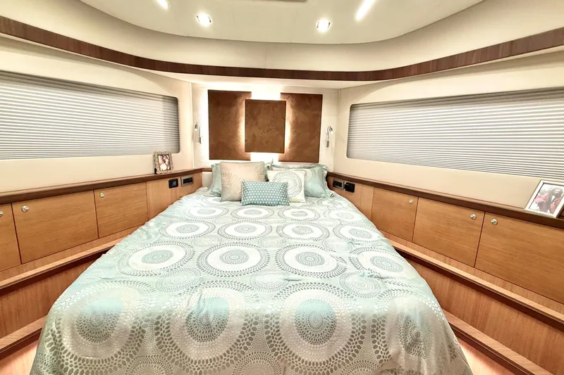  Yacht Photos Pics Luxurious bedroom interior of 2025 Altima Express Coupe 65 yacht, featuring elegant bedding and wood accents.