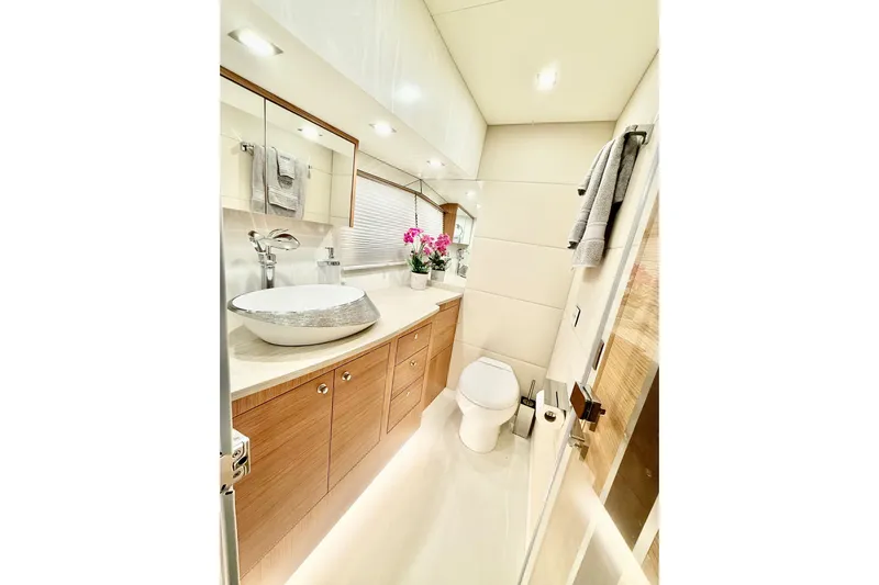  Yacht Photos Pics Luxurious bathroom in 2025 Altima Express Coupe 65 yacht, featuring modern fixtures and elegant design.