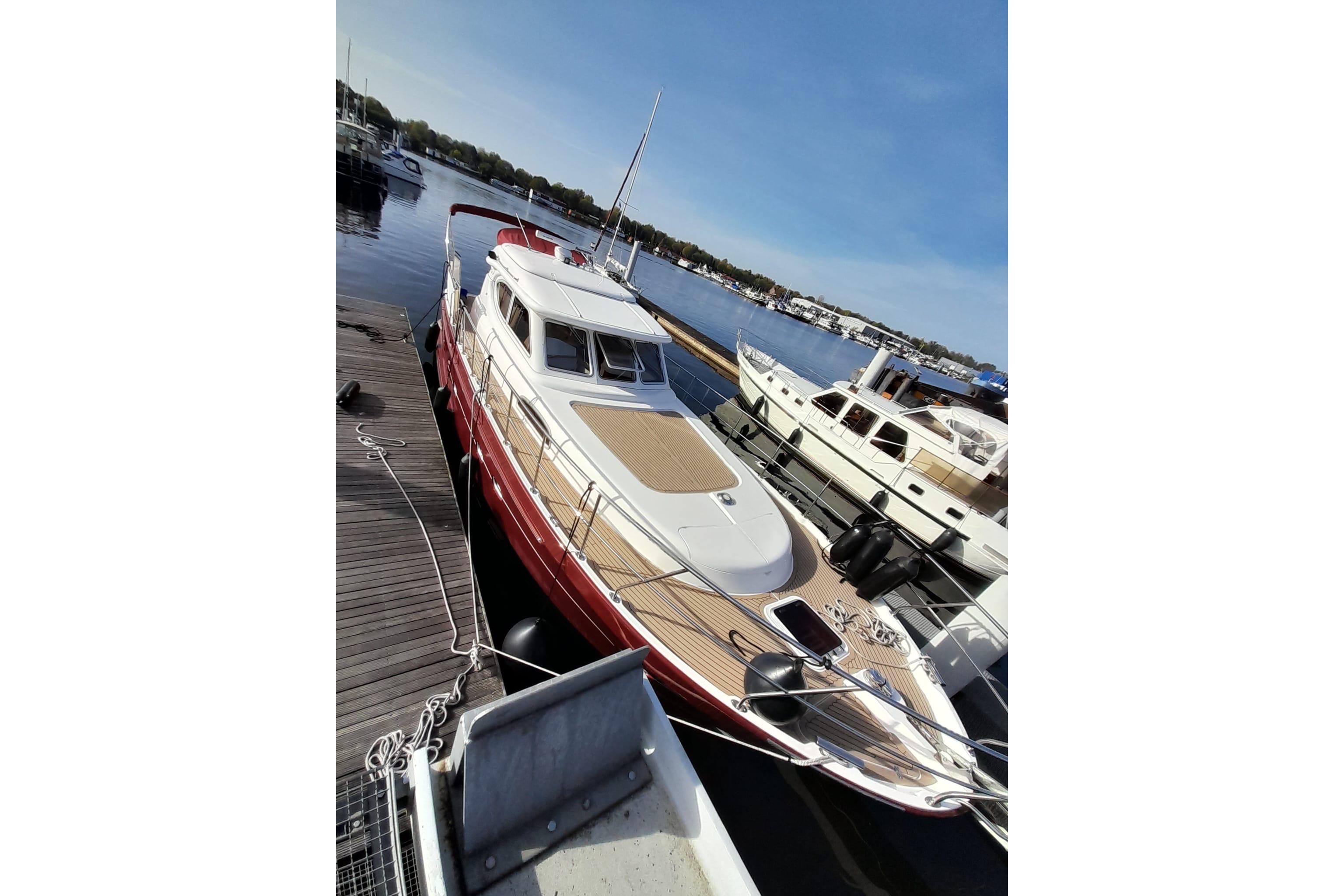 2014 Elling E3 Ultimate yacht docked at marina under clear blue sky.