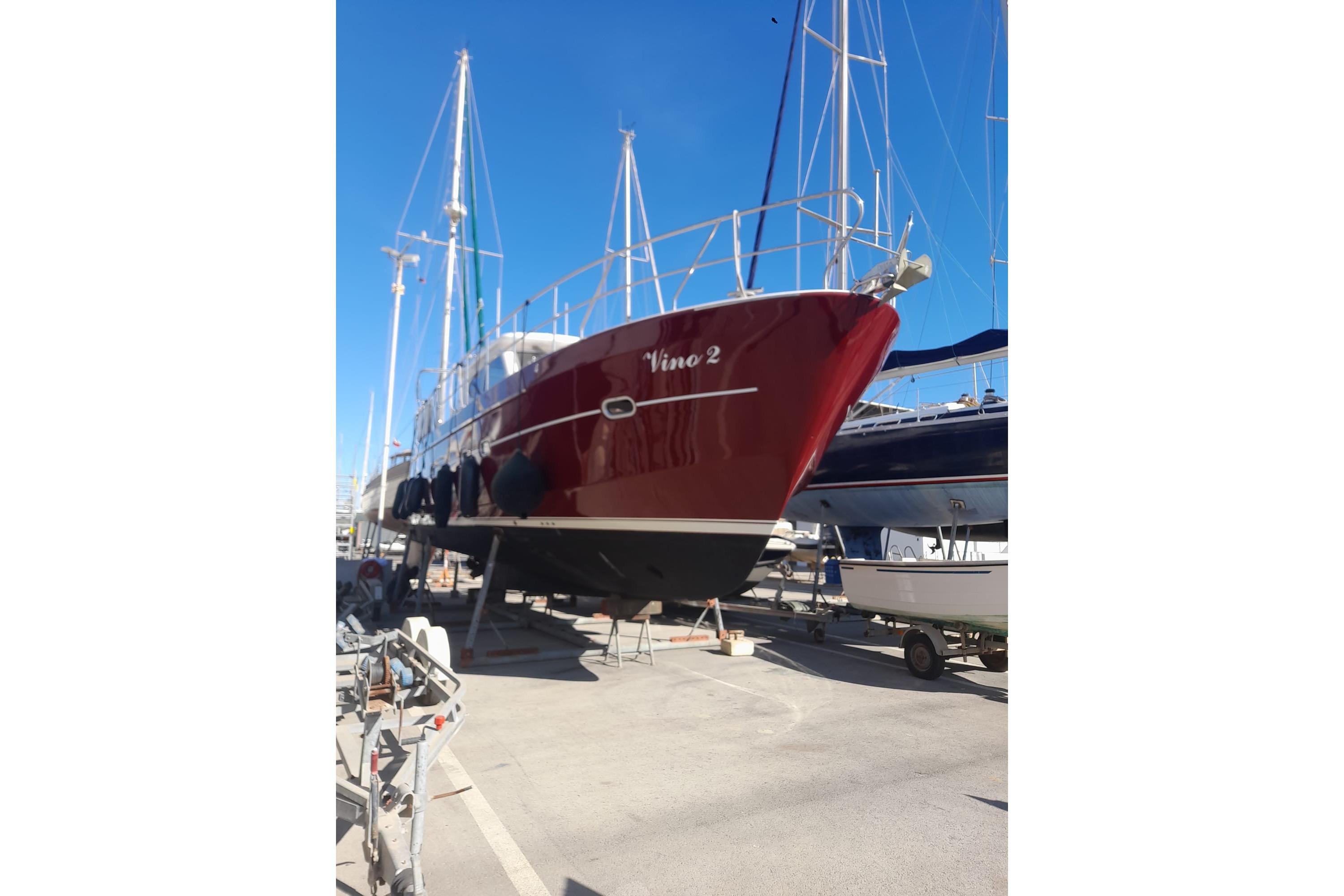 Red Elling E3 Ultimate yacht, 2014 model, docked on land under clear blue sky.