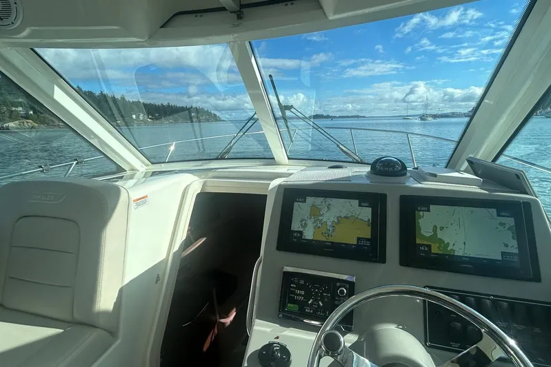  Yacht Photos Pics Interior view of 2016 Boston Whaler 315 Conquest Pilothouse with navigation screens.