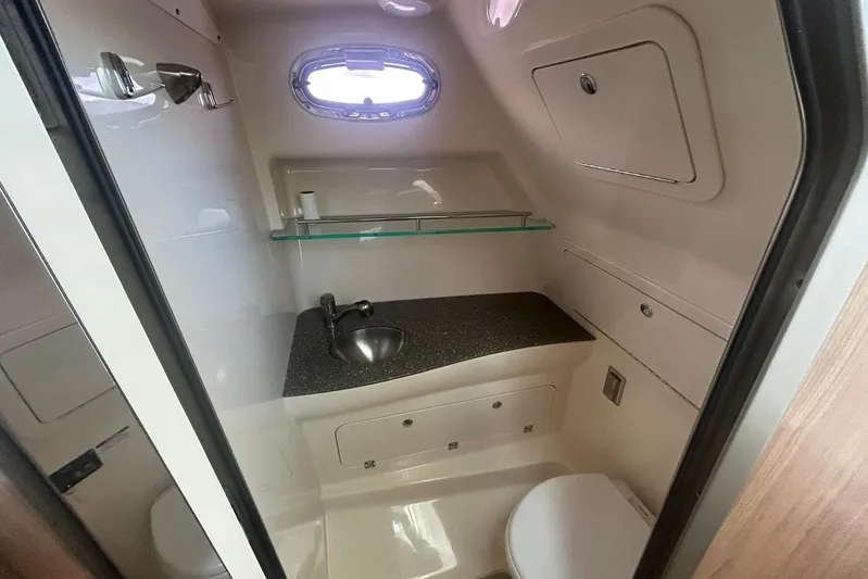  Yacht Photos Pics 2016 Boston Whaler 315 Conquest Pilothouse bathroom with sink, toilet, and storage.