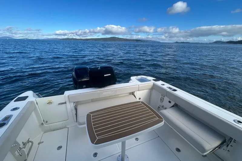  Yacht Photos Pics Boston Whaler 315 Conquest Pilothouse 2016 on open water, featuring spacious deck and seating.