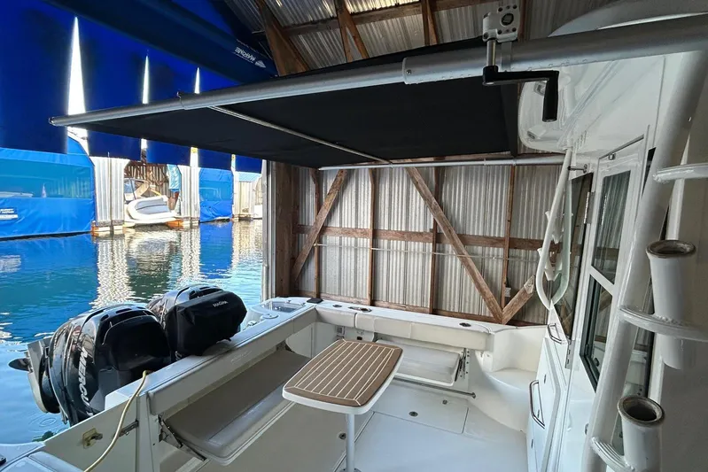 Yacht Photos Pics 2016 Boston Whaler 315 Conquest Pilothouse docked, featuring dual Mercury engines and shaded deck area.