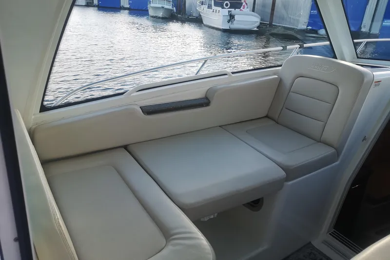  Yacht Photos Pics 2016 Boston Whaler 315 Conquest Pilothouse interior seating with waterfront view.