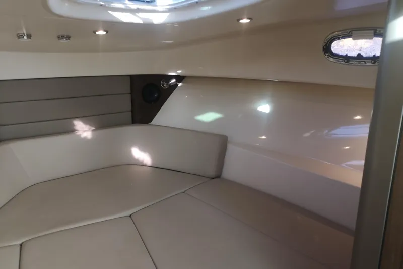  Yacht Photos Pics Interior cabin of 2016 Boston Whaler 315 Conquest Pilothouse, featuring cozy seating and porthole.