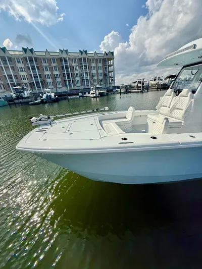  Yacht Photos Pics 2025 Freeman 28 boat docked in marina, with waterfront buildings and cloudy sky.