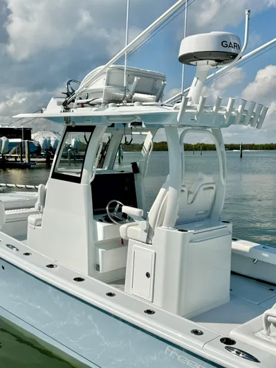  Yacht Photos Pics Freeman 28 boat, 2025 model, with advanced navigation equipment, docked in a marina.