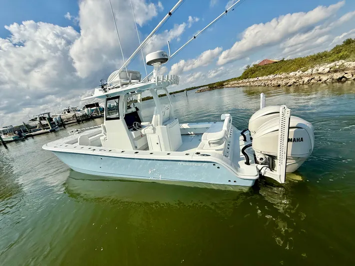  Yacht Photos Pics 2025 Freeman 28 boat with Yamaha engine on calm water under blue sky.