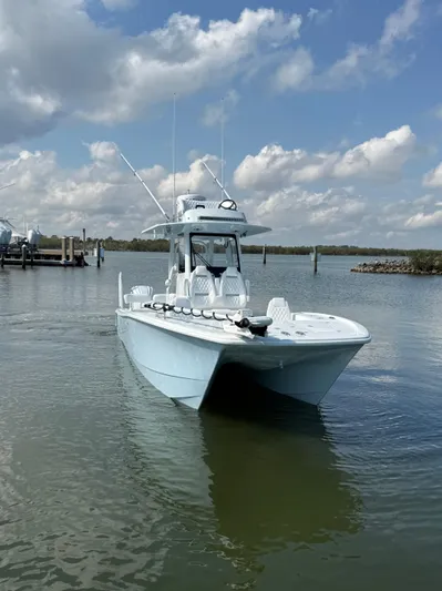 Yacht Photos Pics 2025 Freeman 28 boat on calm water under a partly cloudy sky.