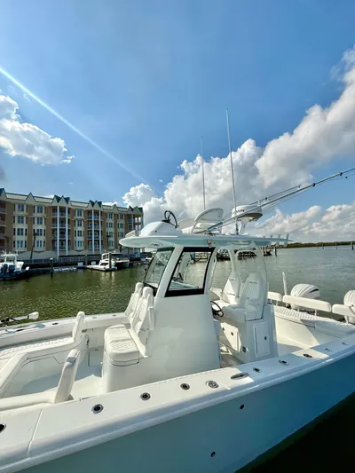  Yacht Photos Pics 2025 Freeman 28 boat docked by waterfront buildings under a clear blue sky.