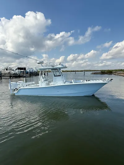  Yacht Photos Pics 2025 Freeman 28 boat on calm water under a partly cloudy sky.