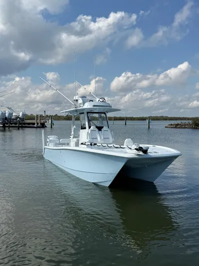  Yacht Photos Pics 2025 Freeman 28 boat on calm water under a partly cloudy sky.