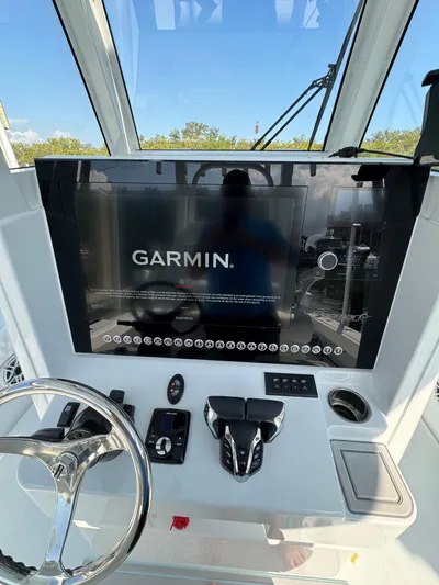  Yacht Photos Pics Freeman 28 boat dashboard with Garmin display, 2025 model, featuring steering wheel and controls.