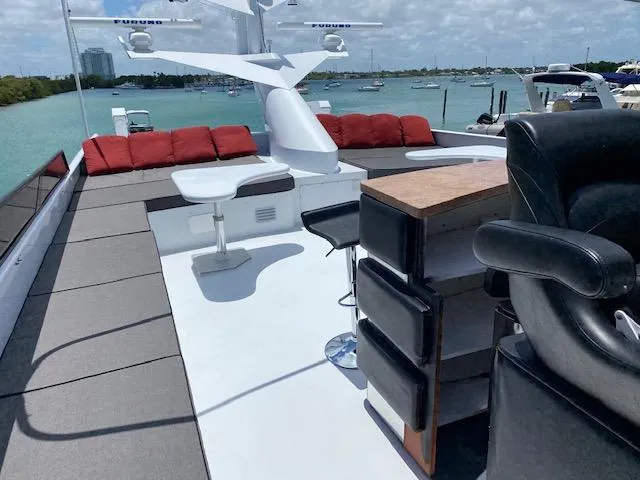 Audacity Yacht Photos Pics Luxurious 1990 Broward Raised Pilothouse MY yacht deck with seating and ocean view.