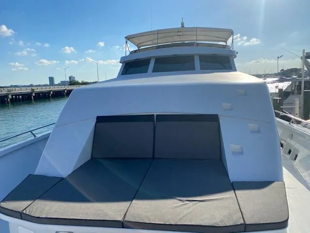Audacity Yacht Photos Pics 1990 Broward Raised Pilothouse MY yacht with sun deck, docked by the water.