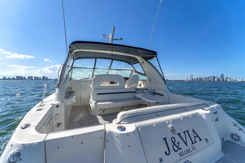  Yacht Photos Pics 1997 Sea Ray 400 Sundancer yacht cruising near Miami skyline under clear blue skies.