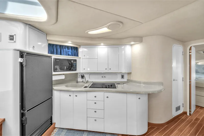  Yacht Photos Pics 1997 Sea Ray 400 Sundancer yacht kitchen with modern appliances and sleek cabinetry.