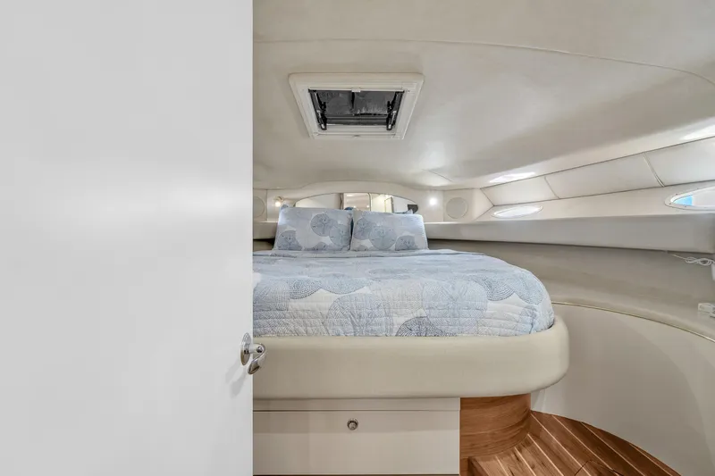  Yacht Photos Pics Cozy bedroom interior of 1997 Sea Ray 400 Sundancer yacht with elegant bedding.