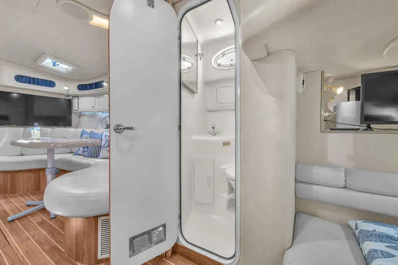  Yacht Photos Pics Interior of 1997 Sea Ray 400 Sundancer yacht with seating, table, and bathroom.