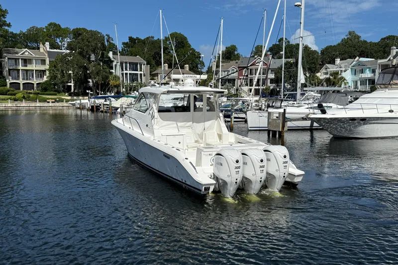 Centra Yacht Photos Pics 2023 Pursuit OS 355 Offshore boat docked in a marina with multiple outboard engines.