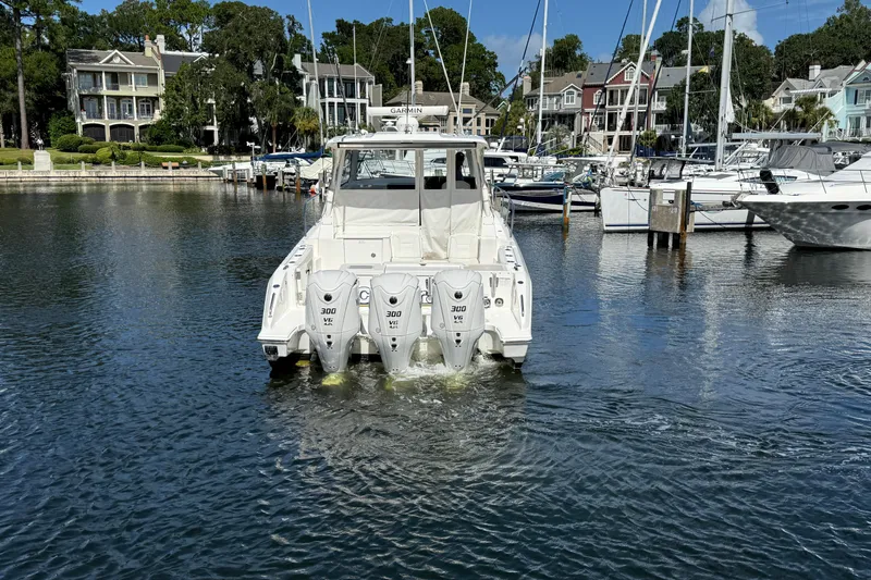 Centra Yacht Photos Pics 2023 Pursuit OS 355 Offshore boat with triple 300 HP engines in a marina setting.