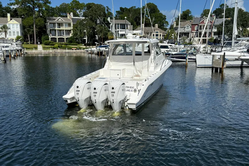 Centra Yacht Photos Pics 2023 Pursuit OS 355 Offshore boat docked in a marina with multiple engines.