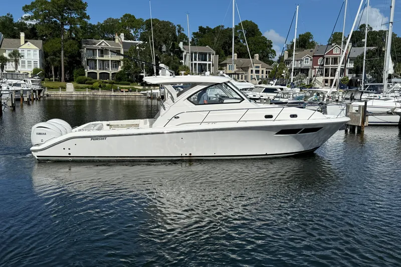 Centra Yacht Photos Pics 2023 Pursuit OS 355 Offshore boat docked in a marina with waterfront homes.