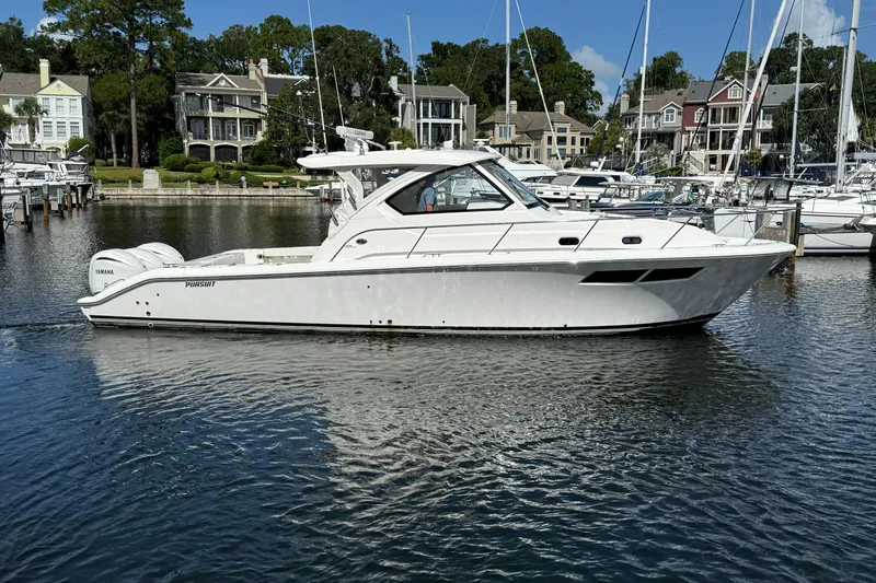 Centra Yacht Photos Pics 2023 Pursuit OS 355 Offshore boat docked in a marina with waterfront homes.