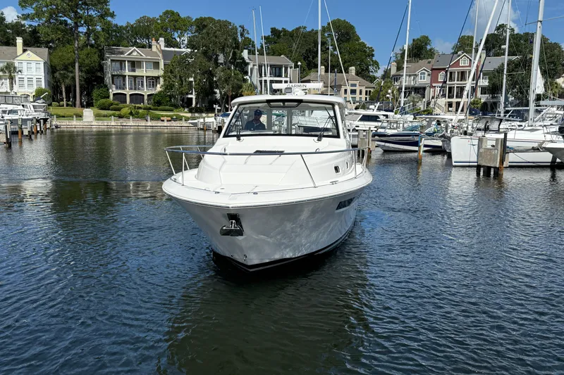 Centra Yacht Photos Pics 2023 Pursuit OS 355 Offshore boat docked in a scenic marina setting.