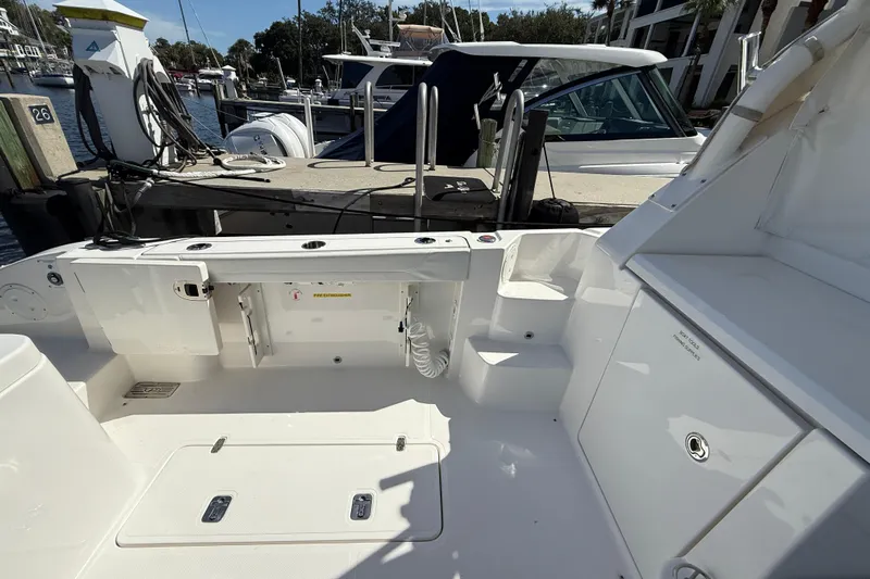 Centra Yacht Photos Pics 2023 Pursuit OS 355 Offshore boat interior at marina dock, showcasing spacious deck layout.