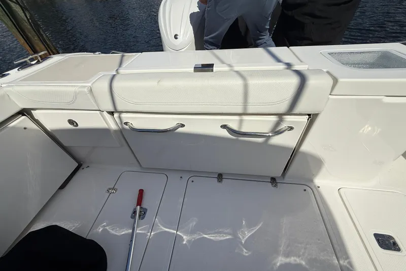 Centra Yacht Photos Pics 2023 Pursuit OS 355 Offshore boat interior with white seating and storage compartments.