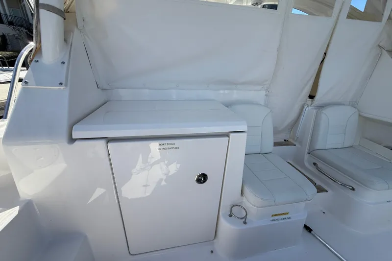 Centra Yacht Photos Pics 2023 Pursuit OS 355 Offshore boat interior with white seating and storage compartment.